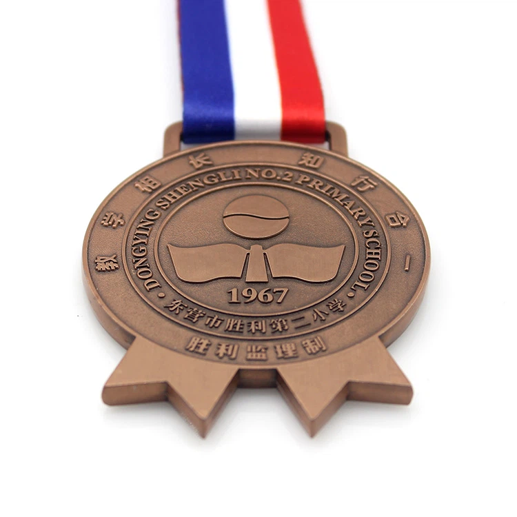 Starožitné bronzové medaile pro školy